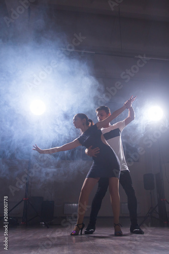 Active happy adults dancing bachata together in dance class