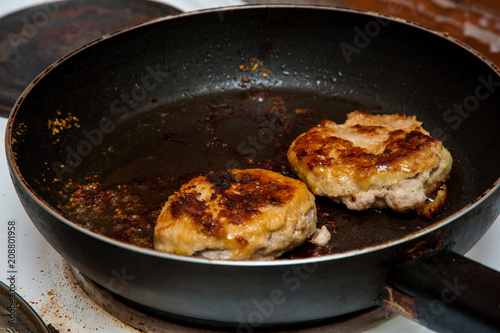 Cutlets fried in a frying pan, fried cutlets to a table