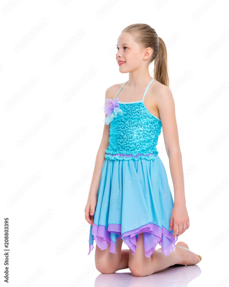 The little gymnast perform an acrobatic element on the floor. The little gymnast perform an acrobatic element on the floor.