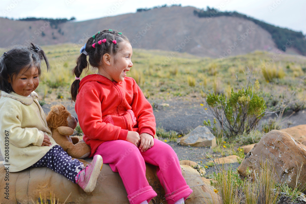 Two happy latin kids sitting on the stone and having a good time. Two happy latin kids sitting on the stone and having a good time.