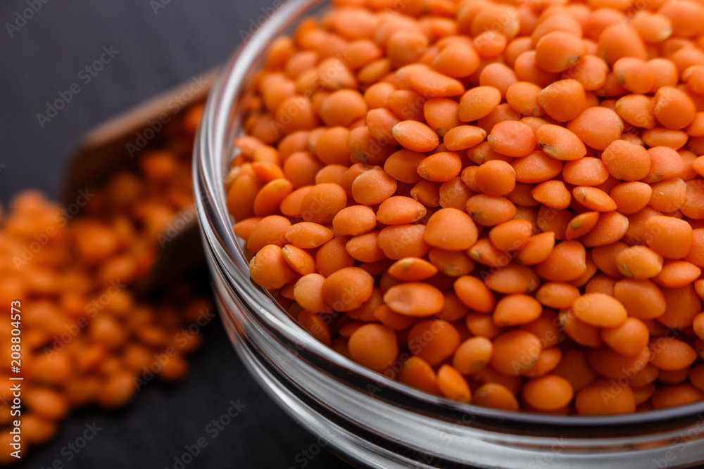 raw lentils on a dark stone background raw lentils on a dark stone background