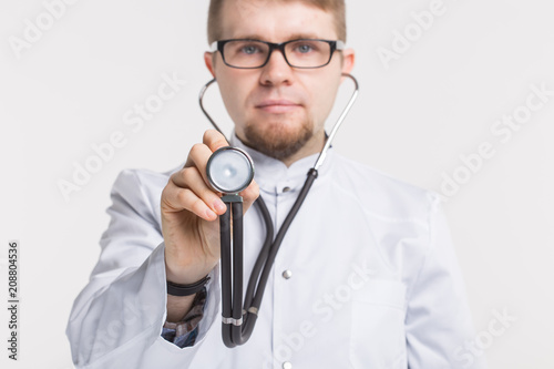 Close up of doctor man with stethoscope over white background with copy space