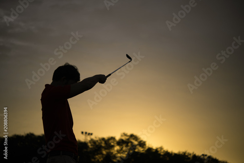 silhouette asian golfer playing golf during beautiful sunset,Thailand people