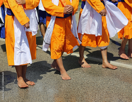 Sikh barefoot soldiers wear an orange dress