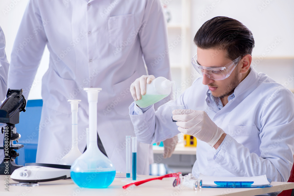 Team of chemists working in the lab Team of chemists working in the lab