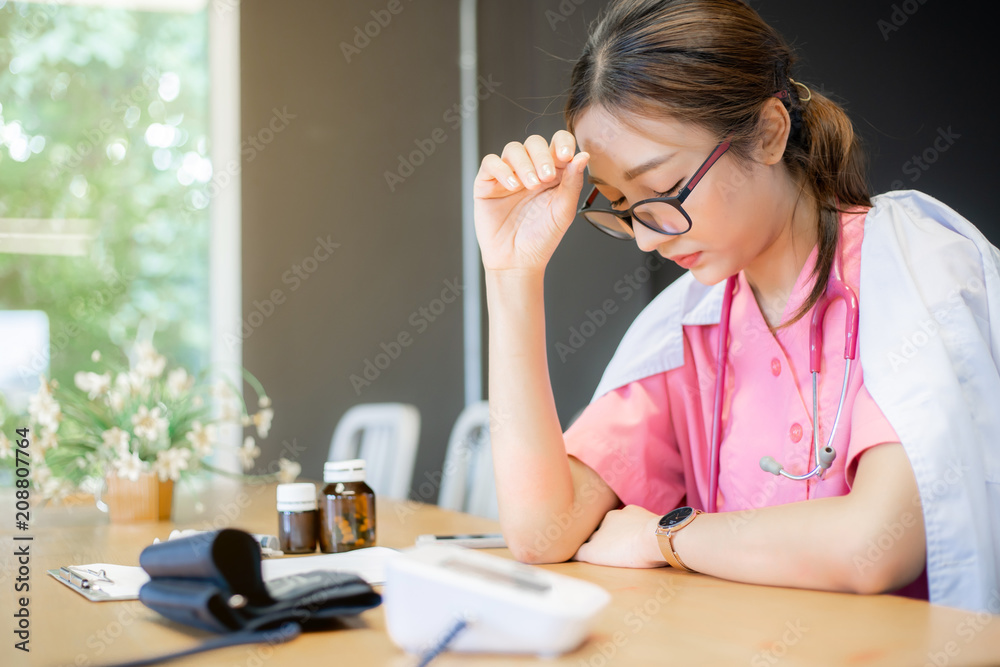 Doctor with headache stressed Nurse doctor with migraine headache Doctor with headache stressed Nurse doctor with migraine headache