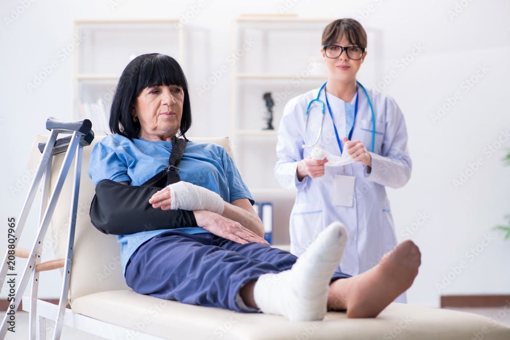 Doctor examining old mature woman after incident Doctor examining old mature woman after incident
