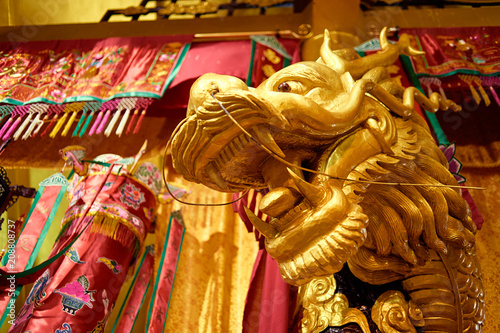 Statue of golden Chinese dragon on temple in Phuket, Thailand.