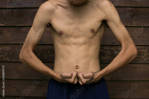Slim Muscle man pretending to show the wooden floor backdrop.