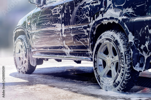 Washing car black with active foam