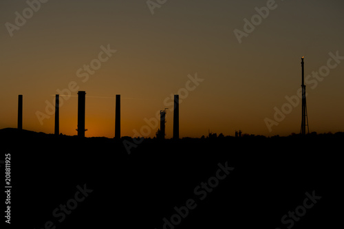 A plane going through the refinery sky