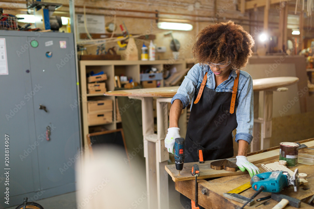 Afro american woman craftswoman working in her workshop
Afro american woman craftswoman working in her workshop