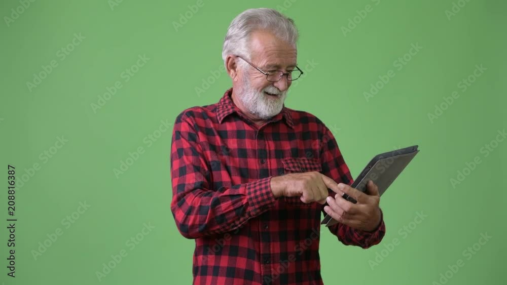 Handsome senior bearded man against green background Handsome senior bearded man against green background