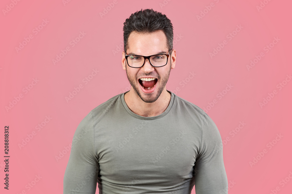 An emotional crazy young man is shouting loudly and with anger. An emotional crazy young man is shouting loudly and with anger.
