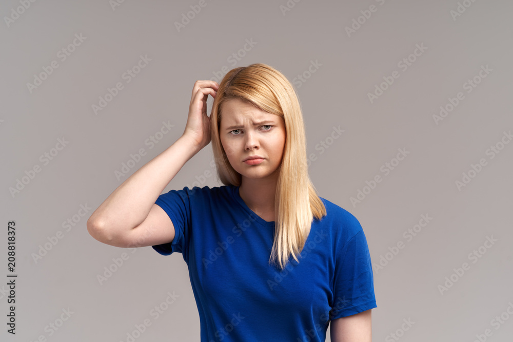 The girl looks thoughtfully to the side, suffers from a headache after an experienced event in life, feels bad. The girl looks thoughtfully to the side, suffers from a headache after an experienced event in life, feels bad.
