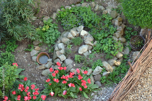 Permacultural element - herb spiral in spring season