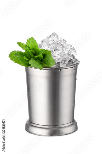 Silver mug with mint leaves and crushed ice