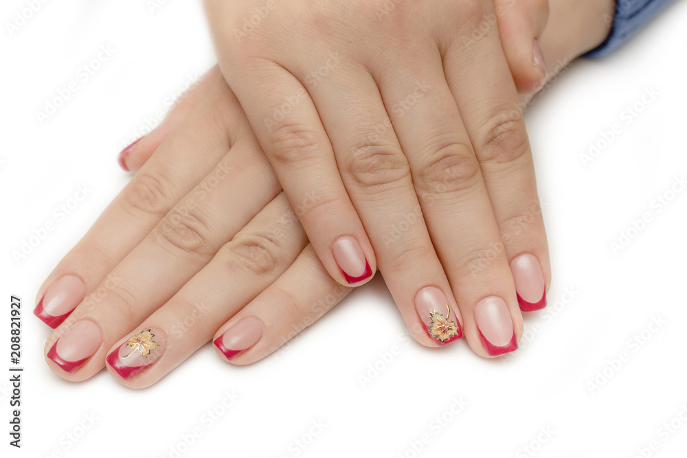 Manicure with rhinestones in the shape of hearts and pink balls on white and red nail Polish on a white background. Manicure with rhinestones in the shape of hearts and pink balls on white and red nail Polish on a white background.