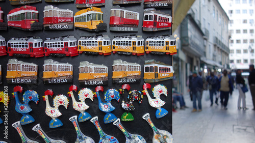 Magnetic trams and Galo de Barcelos (Barcelos Rooster). Typical souvenir of Lisbon.    