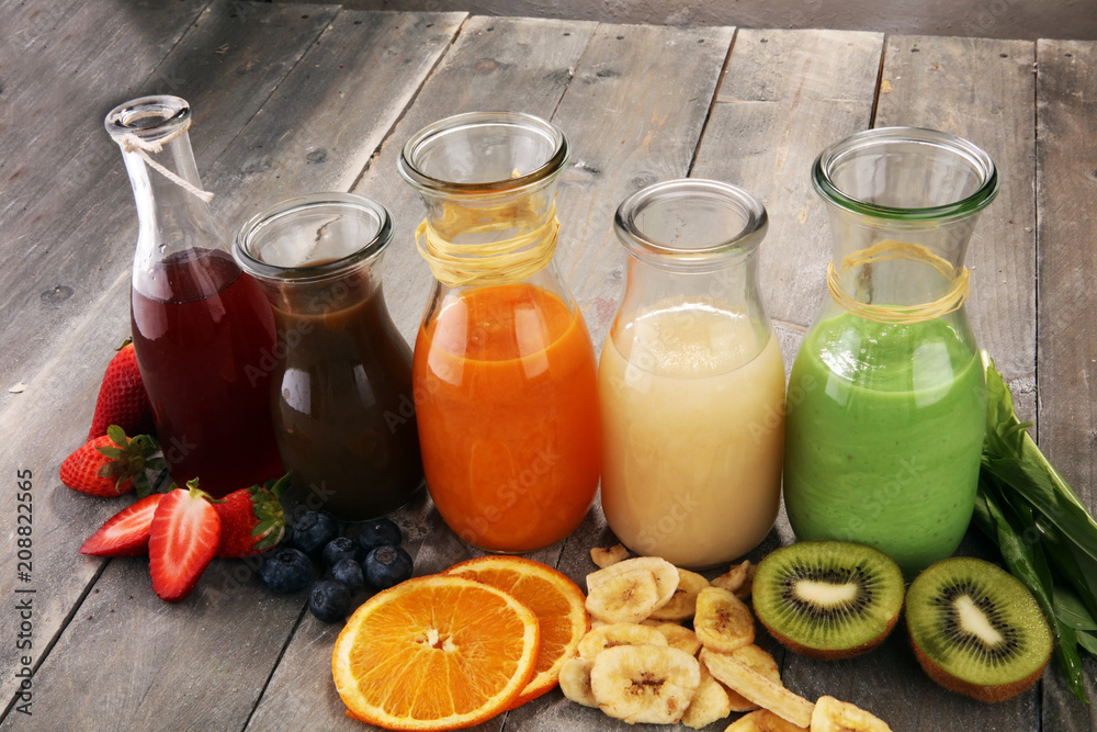 Selection of colorful smoothies on rustic background Selection of colorful smoothies on rustic background