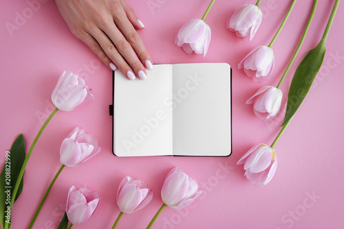 Manicure, notebook and flowers photo