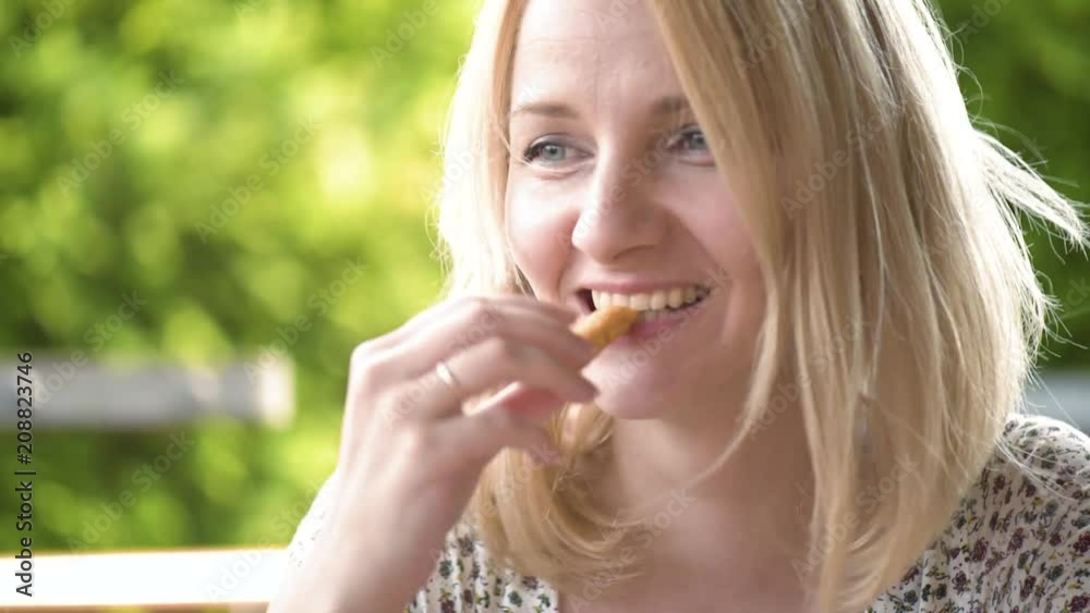 Hungry young woman enjoying fresh eating french fries in fast food restaurant. Hungry young woman enjoying fresh eating french fries in fast food restaurant.
