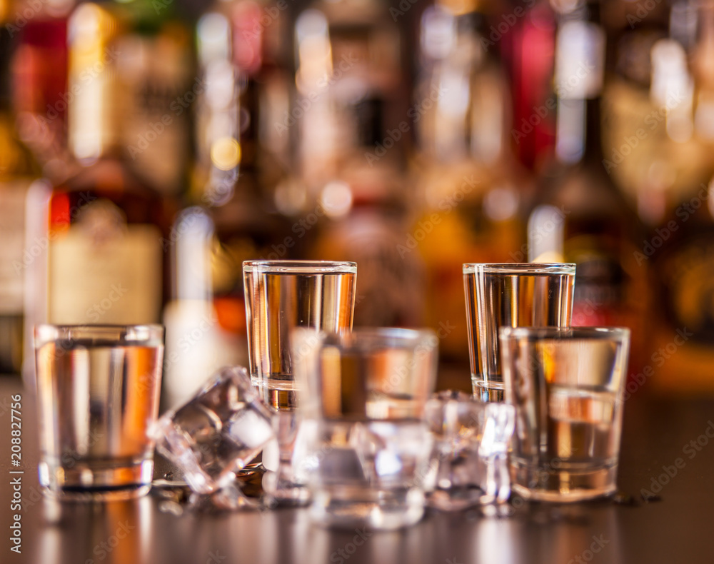 Traditional pure vodka in glasses on a black background, chilled drink