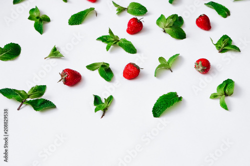 Strawberries and fresh mint on white background, berry pattern