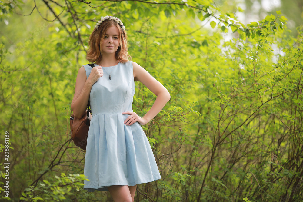 Girl in blue dress in green park Girl in blue dress in green park