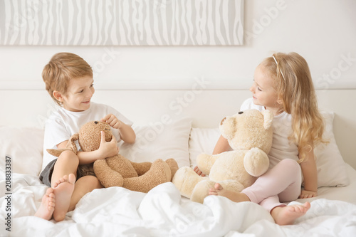 Cute children with toys on ...