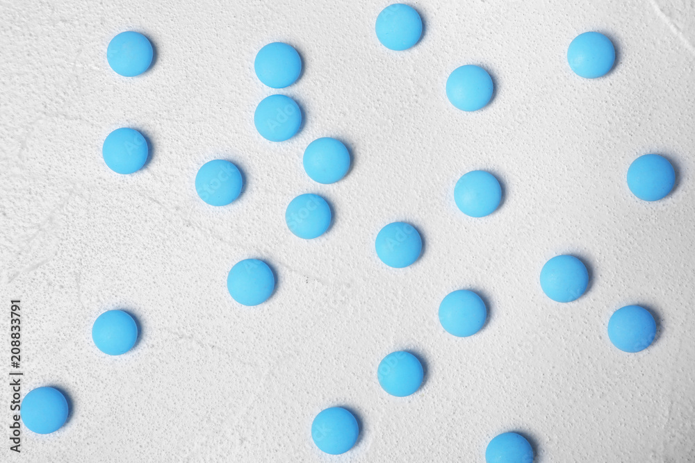 Blue pills on white background, flat lay Blue pills on white background, flat lay