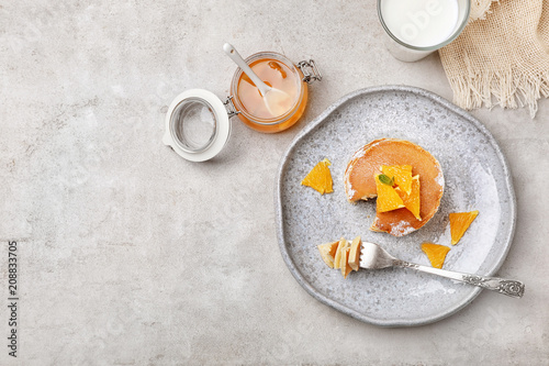 Flat lay composition with tasty pancakes on grey background