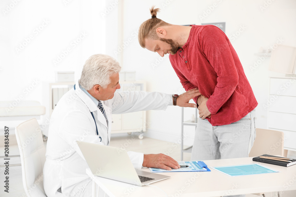 Fototapeta premium Man with health problems visiting urologist at hospital