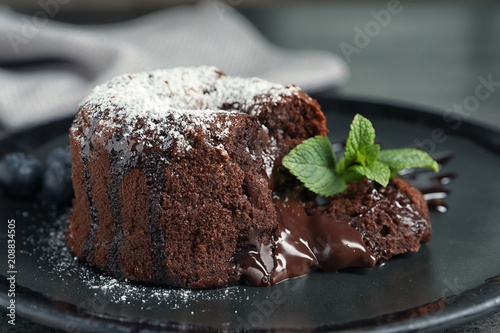 Delicious fresh fondant with hot chocolate and blueberries served on plate. Lava cake recipe
