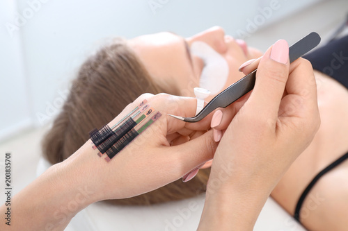 Beautician preparing for eyelash extensions procedure, closeup