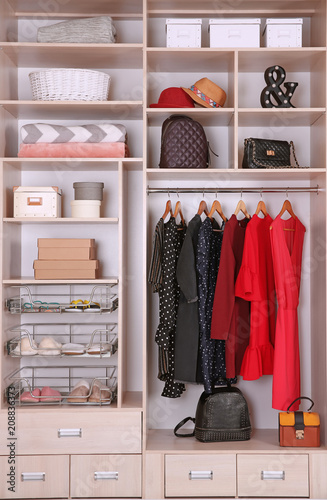 Large wardrobe with different clothes and home stuff