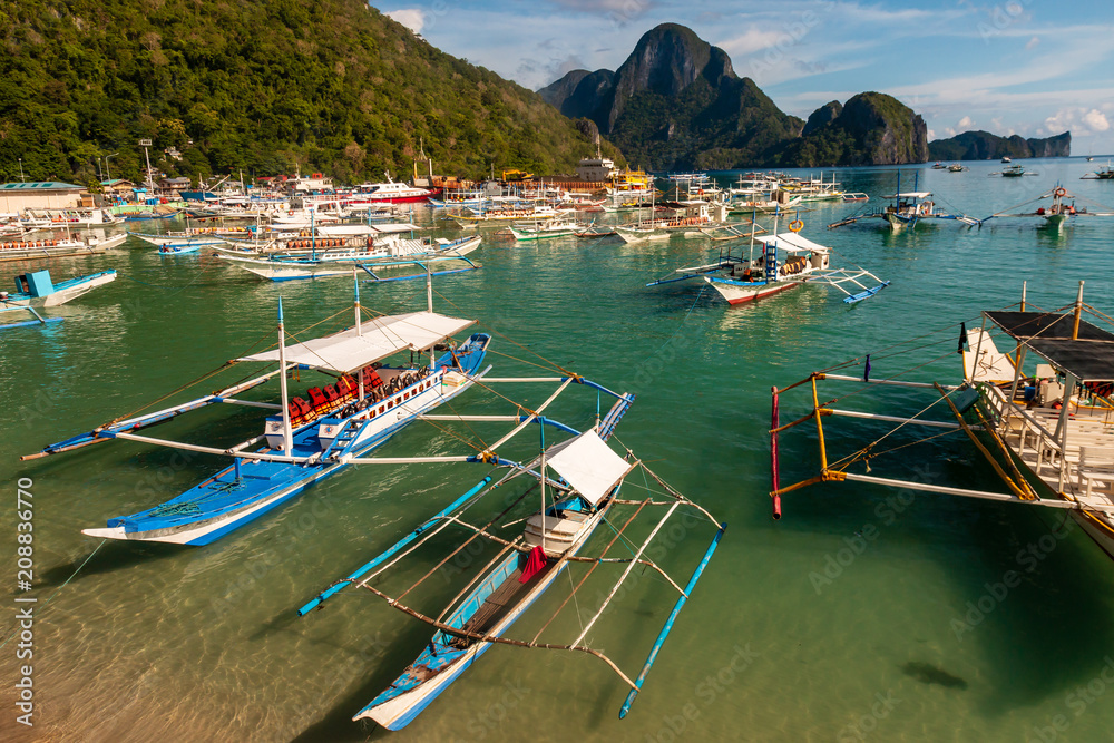 Hundreds of traditional wooden Banca boats wait at a port in El Nido, Palawan