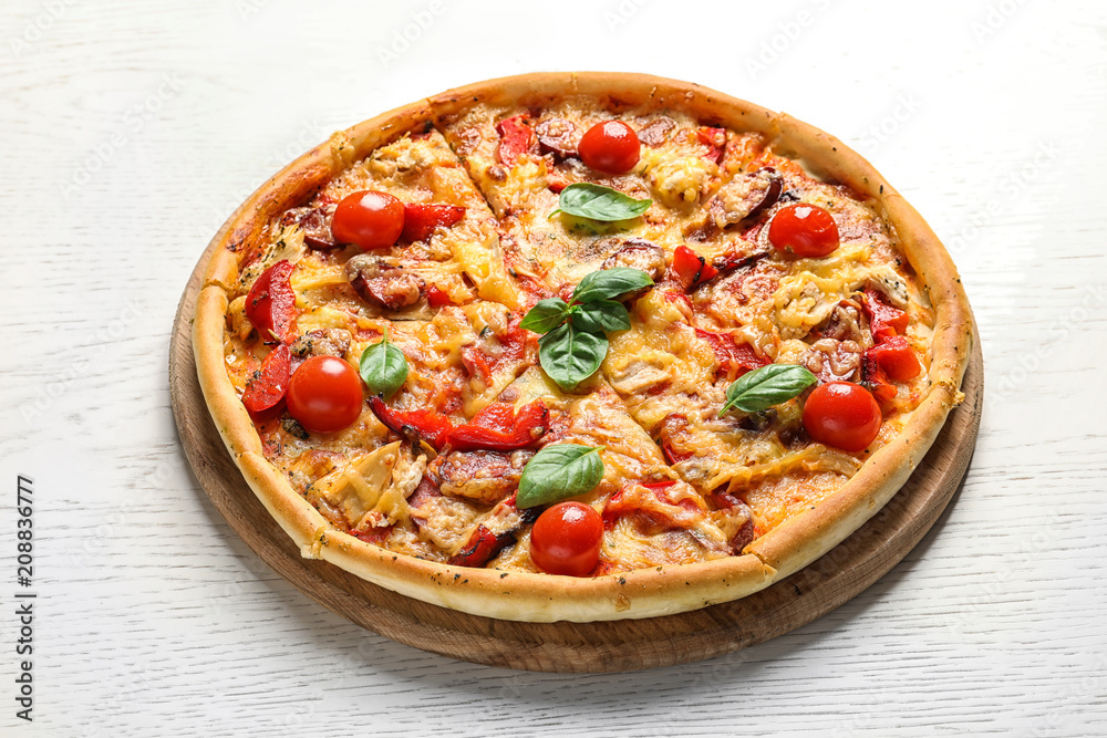 Delicious pizza with tomatoes and sausages on table