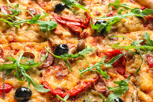 Delicious pizza with olives and sausages, closeup
