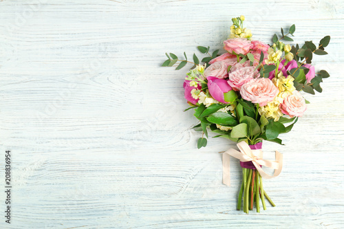 Bouquet of beautiful fragrant flowers on wooden background