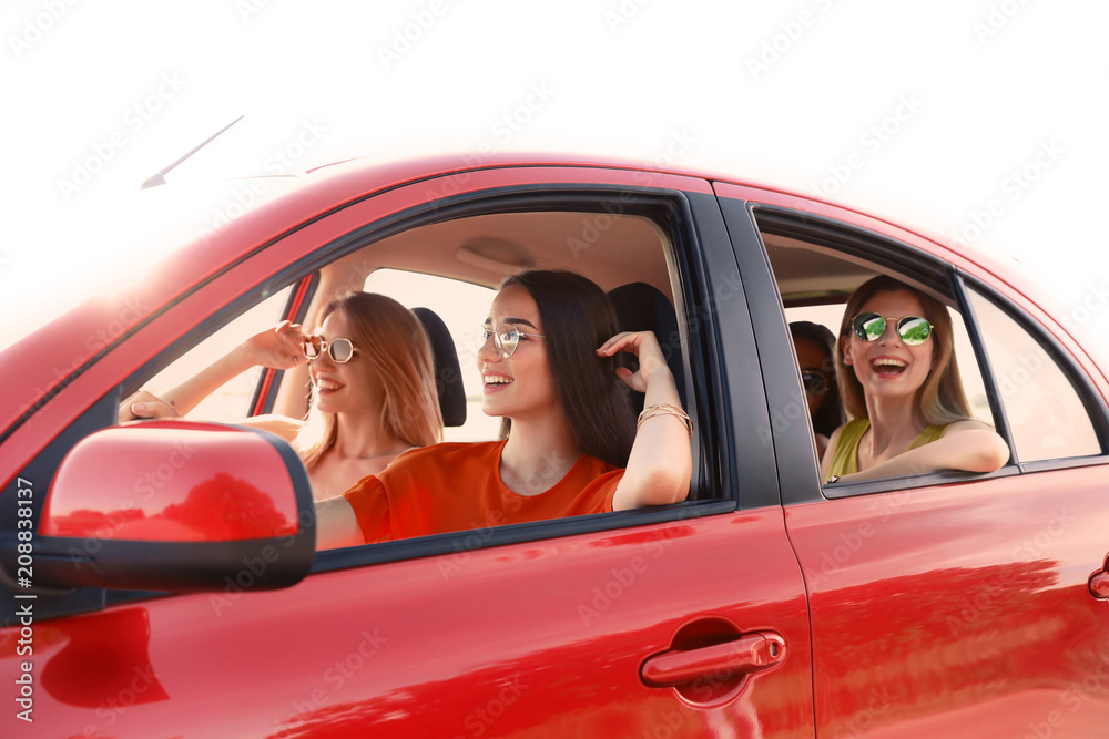 Happy beautiful young women together in car Happy beautiful young women together in car