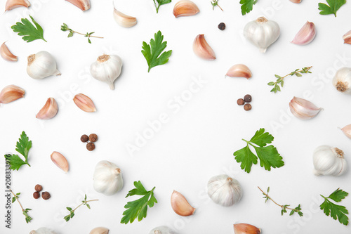 Flat lay composition with garlic on light background