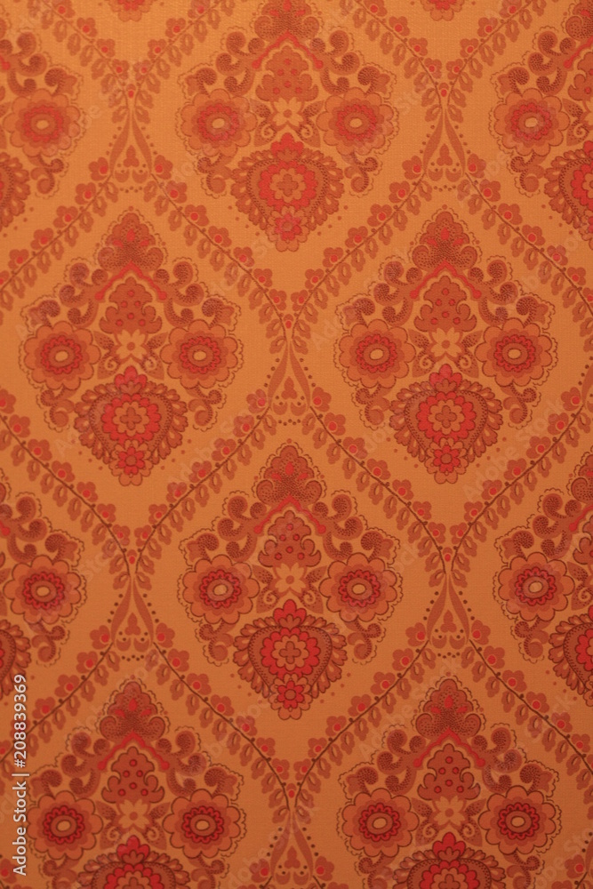 orange 70's wallpaper with repeating paisley pattern in an old house orange 70's wallpaper with repeating paisley pattern in an old house
