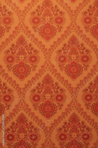 orange 70's wallpaper with repeating paisley pattern in an old house
