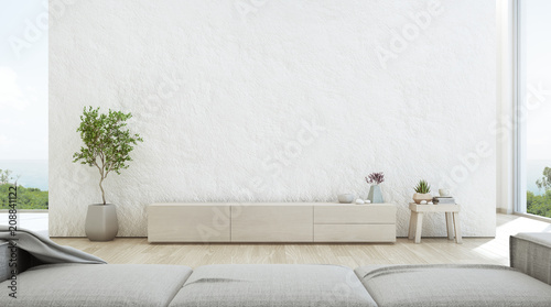 Sea view living room of luxury summer beach house with TV stand and wooden cabinet. Empty rough white concrete wall background in vacation home or holiday villa. Hotel interior 3d illustration.