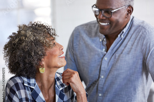 Senior African American couple at home smiling at each other