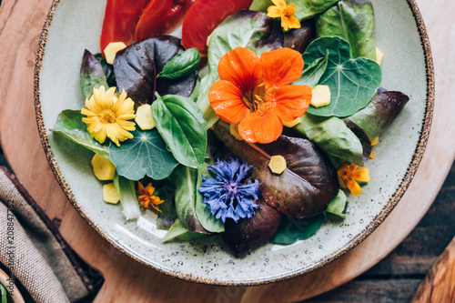 Delicious salad with edible flowers photo