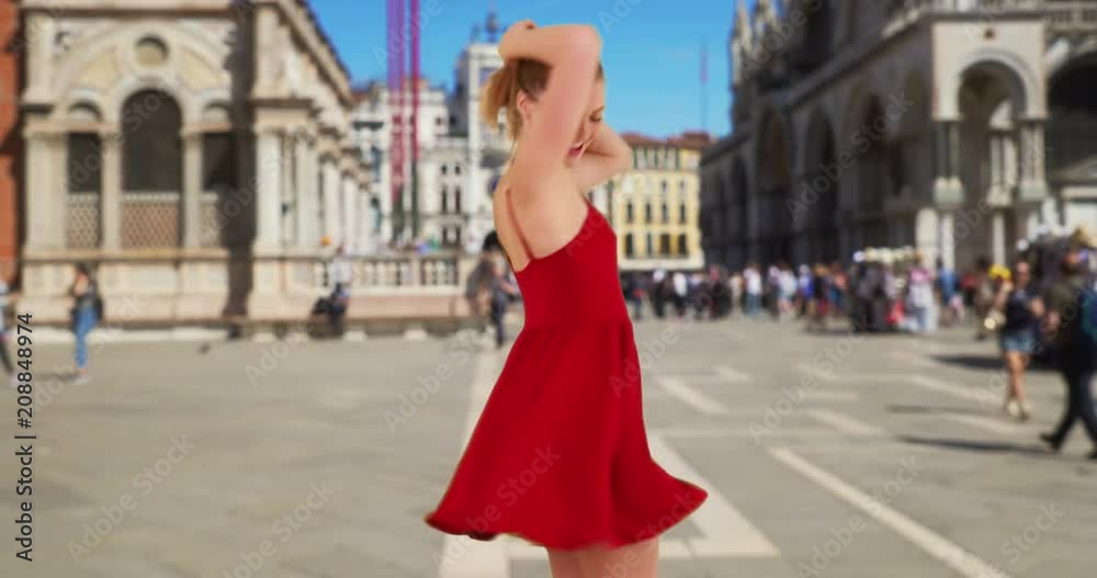 Carefree woman in Venice twirling in red sundress laughing and smiling, Pretty Caucasian girl in he 20s having fun in St, Mark's Square, 4k Carefree woman in Venice twirling in red sundress laughing and smiling, Pretty Caucasian girl in he 20s having fun in St, Mark's Square, 4k