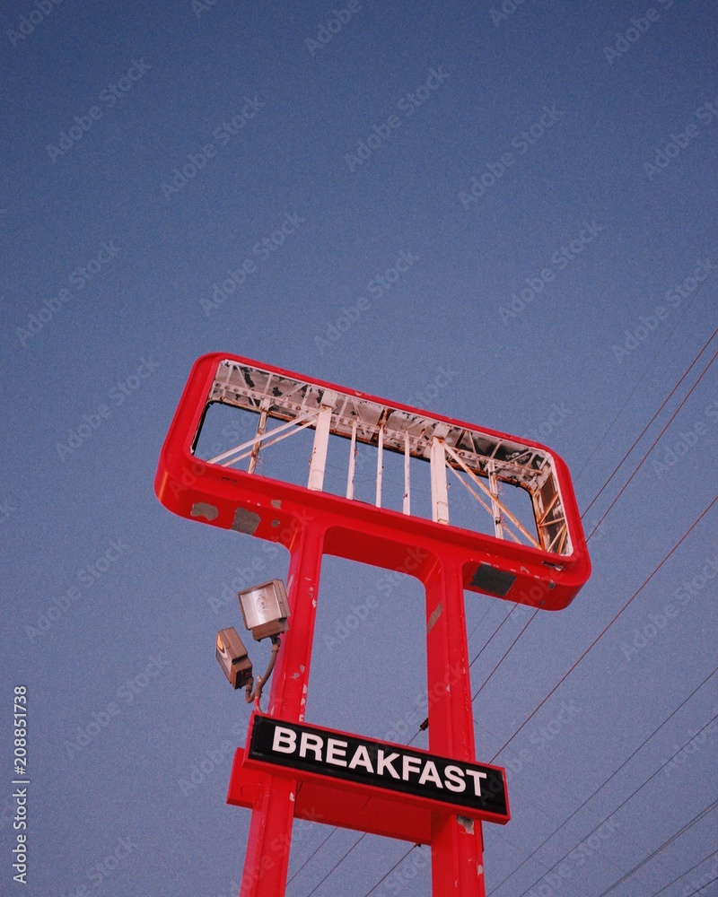 Abandoned red marquee with a breakfast sign in front of a twilight sky Abandoned red marquee with a breakfast sign in front of a twilight sky
