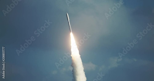 Tracking shot of missile rocket flying into space after launch